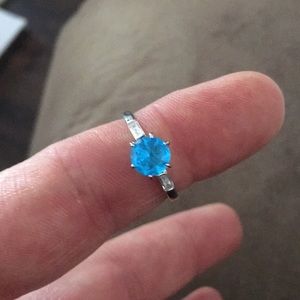 Silver ring with a blue stone (New).